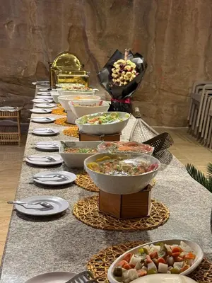 a long table filled with bowls and plates of food at Rum Royal Dunes Camp & tour in Wadi Rum