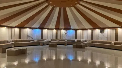 a large room with a tent with chairs and tables at Rum Royal Dunes Camp & tour in Wadi Rum