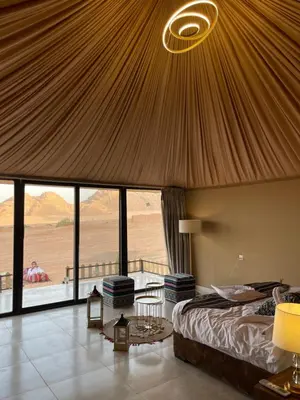a bedroom with a bed and a view of the desert at Rum Royal Dunes Camp & tour in Wadi Rum