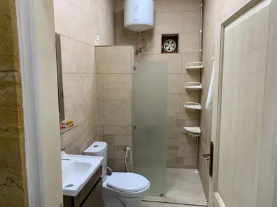 a small bathroom with a toilet and a sink at Tayoon Host in Jerash