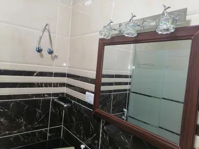 a bathroom with a mirror and a sink at Petra Guests home in Wadi Musa