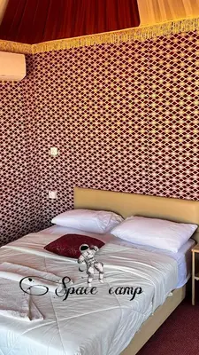 a bed with a teddy bear on top of it at Wadi Rum Space camp in Wadi Rum