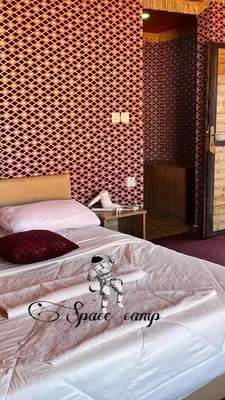 a room with a bed with a sign on it at Wadi Rum Space camp in Wadi Rum