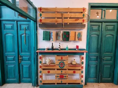 a room with two blue doors and a table at Shams House in Amman
