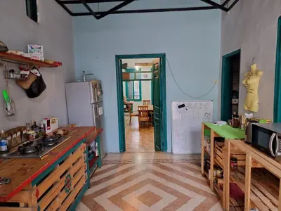 a kitchen with a refrigerator and a table in it at Shams House in Amman
