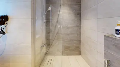 a shower with a glass door in a bathroom at Al Fares Luxury furnished Apartment-Damac Tower in Amman