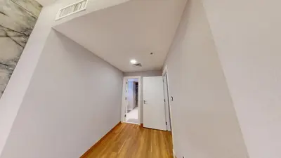 an empty hallway with white walls and wood floors at Al Fares Luxury furnished Apartment-Damac Tower in Amman