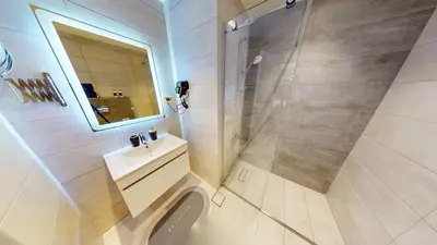 a bathroom with a shower and a sink and a toilet at Al Fares Luxury furnished Apartment-Damac Tower in Amman
