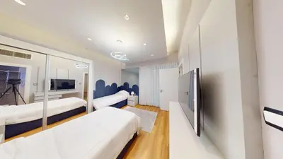 a hotel room with two beds and a mirror at Al Fares Luxury furnished Apartment-Damac Tower in Amman