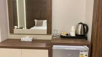 a hotel room with a bed and a mirror at Mass Boutique hotel in Aqaba