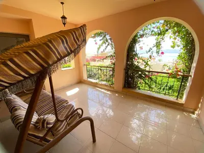a room with two arched windows and a bench in a room at one bedroom apartments aqaba on for family only 2 swimming pool Tala bay for family only in Aqaba