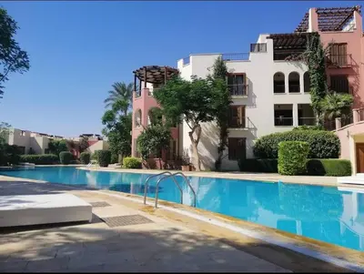 a swimming pool in front of a building at one bedroom apartments aqaba on for family only 2 swimming pool Tala bay for family only in Aqaba