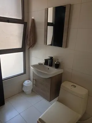 a bathroom with a sink and a toilet at Deir Ghbar-Studio in Amman
