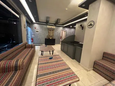 a living room with two chairs and a table at Sandra Hotel in Amman