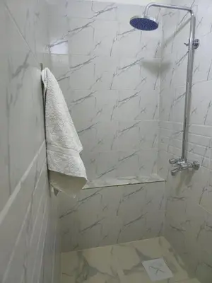 a bathroom with a shower with a towel at Petraone in Wadi Musa