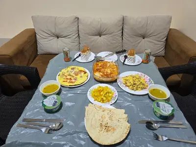 a blue table with plates of food on it at Petraone in Wadi Musa