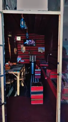 a room with a pile of books and a table at Its your choice hostel in Wadi Musa