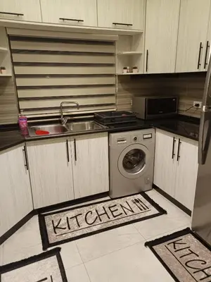 a kitchen with a sink and a washing machine at Villa Jana chalet - Private Villa - Dead Sea - Jordan in Ash Shāghūr
