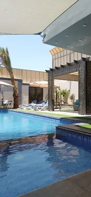 a swimming pool in front of a building at Villa Jana chalet - Private Villa - Dead Sea - Jordan in Ash Shāghūr