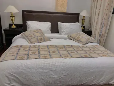 a large white bed with two pillows on it at ZRIZIRA INN in Wadi Musa