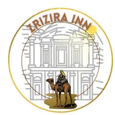a man riding a camel in front of a city at ZRIZIRA INN in Wadi Musa