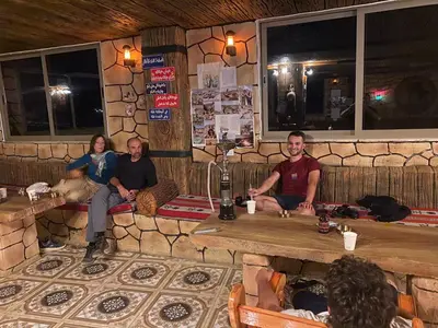 a group of people sitting in a bar at Dana Nabil Ecu Camp House - Main Gate Dana nature reserve in Dana