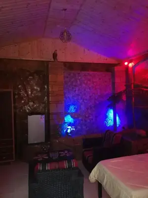 a room with purple and blue lighting and a bed at Yaso Roof & Apartments in Amman