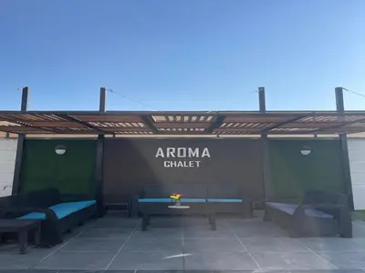 a patio with benches and a sign that readsarma shield at Aroma Chalet in Sowayma