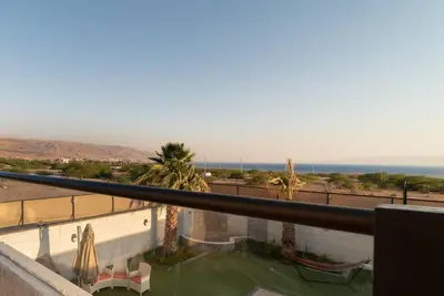 a view of the ocean from the balcony of a building at Aroma Chalet in Sowayma