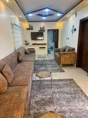 a large living room with a large brown couch at شقه فندقيه.Apartment,Petra in Wadi Musa