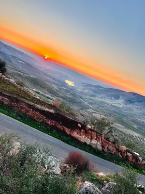 a view of a road with the sunset in the background at شقة سيلا in Irbid
