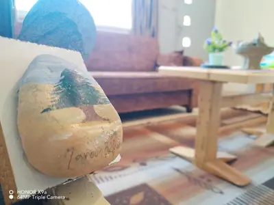a couch sitting in a living room next to a table at Beit Philodemus in Um Qeis