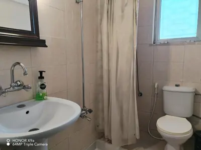 a bathroom with a sink and a toilet and a shower at Beit Philodemus in Um Qeis