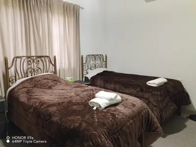 two beds sitting next to each other in a room at Beit Philodemus in Um Qeis