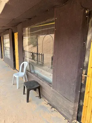 a chair sitting next to a window on a train at Rum Luxury Camp in Wadi Rum