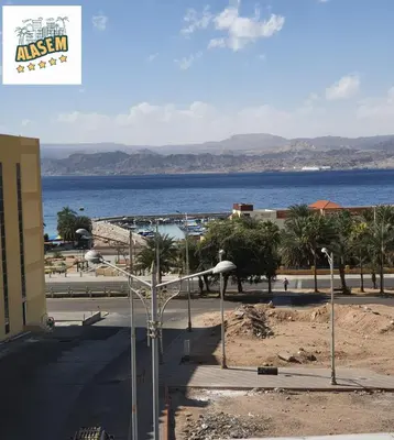 a view of the ocean from a building with a street light at العاصم للشقق الفندقية ALASEM HOTEL APARTMENTS in Aqaba