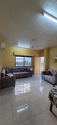 a large living room with couches in a room at العاصم للشقق الفندقية ALASEM HOTEL APARTMENTS in Aqaba