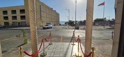 a view of a parking lot with red rope at العاصم للشقق الفندقية ALASEM HOTEL APARTMENTS in Aqaba