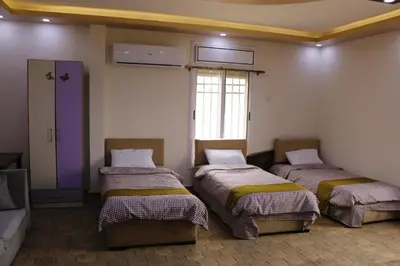 a room with three beds in a room at Petra Mountain House in Wadi Musa