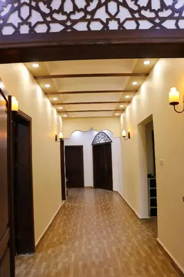 an empty hallway with a coffered ceiling and wood floors at Petra Mountain House in Wadi Musa