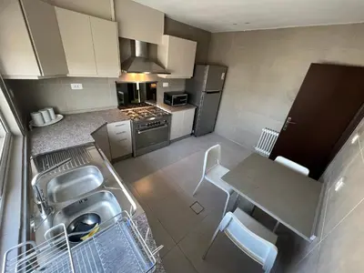 an overhead view of a kitchen with a table and chairs at Bedouin Break Condo - In the Heart of Amman in Amman