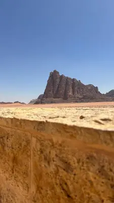 a view of the desert with rocks in the background at altair luxury rum in Wadi Rum