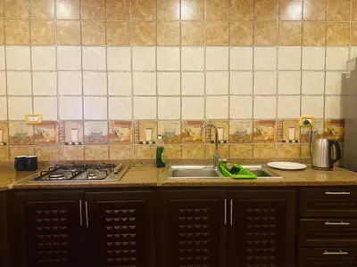 a kitchen with a sink and a stove at Green houseجوهره الشمال in Ajloun