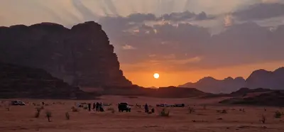 a group of people in the desert at sunset at Maestro camp Wadi Rum in Wadi Rum