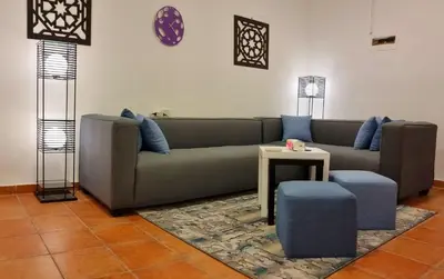a living room with a couch and a table at Byblos Aqaba in Aqaba