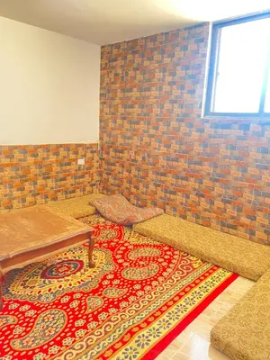 a room with a table and a rug on the floor at Apartment in madba in Madaba