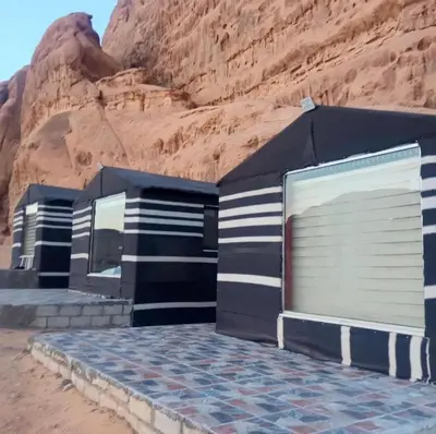 a row of garages in the desert near a mountain at Star rum in Wadi Rum