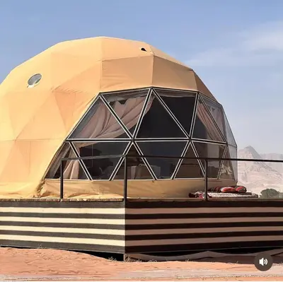 a dome shaped tent sitting in the desert at Star rum in Wadi Rum