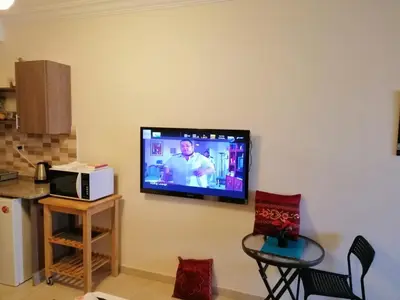 a flat screen tv hanging on a wall at Abdoun studio in Amman