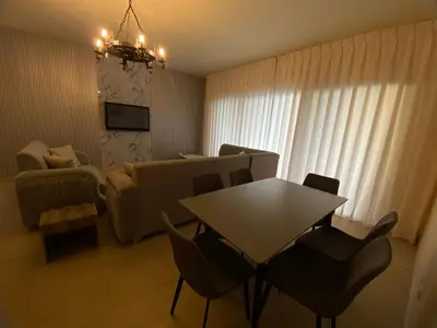 a living room with a table and a couch at Tala bay apartments 2 bedroom for family only in Aqaba